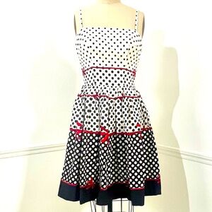 Vintage 1950s summer cocktail dress, black and white Polk dots and red bows.